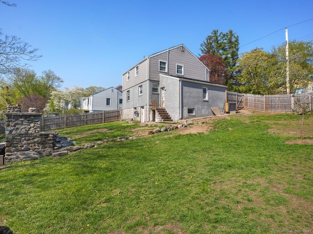 134 Painter Ave, West Haven, CT 06516 - back of property with a yard, a fenced backyard, and entry steps