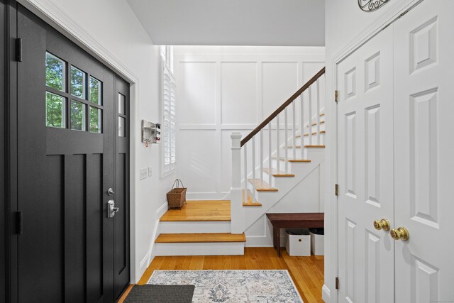 202 Horse Hill Rd, Westbrook, CT 06498 - foyer entrance with stairway, light wood-style floors, and a decorative wall