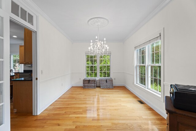 202 Horse Hill Rd, Westbrook, CT 06498 - dining area featuring a chandelier, crown molding, light wood-style flooring, and baseboards
