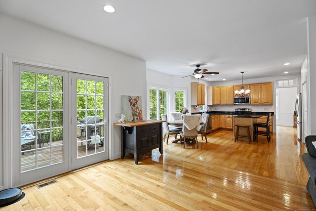 202 Horse Hill Rd, Westbrook, CT 06498 - kitchen featuring appliances with stainless steel finishes, dark countertops, light wood finished floors, recessed lighting, and a chandelier