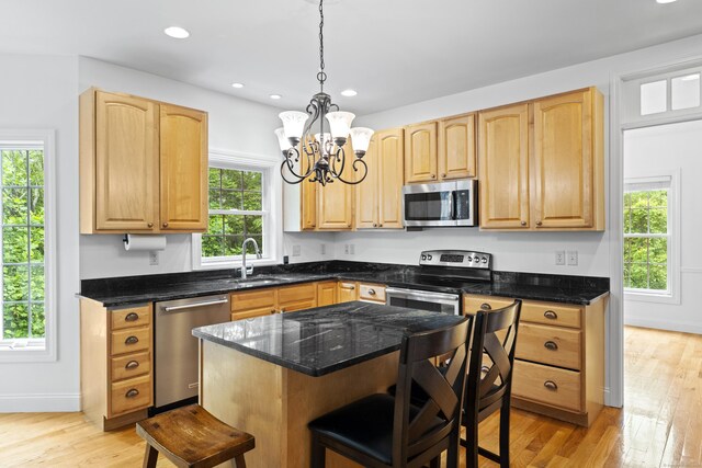 202 Horse Hill Rd, Westbrook, CT 06498 - kitchen with appliances with stainless steel finishes, a kitchen bar, a chandelier, light wood finished floors, and recessed lighting