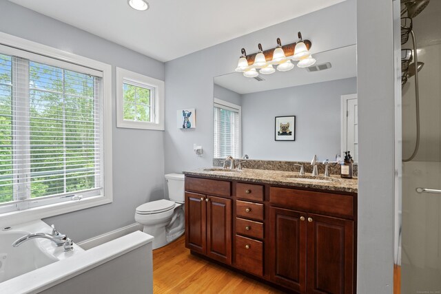 202 Horse Hill Rd, Westbrook, CT 06498 - bathroom with double vanity, toilet, wood finished floors, a garden tub, and a shower