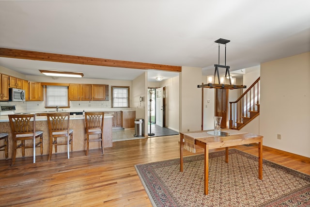 38 Skyline Dr, Brookfield, CT 06804 - dining area featuring light wood-type flooring, stairway, beam ceiling, and baseboards