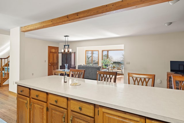 38 Skyline Dr, Brookfield, CT 06804 - kitchen with light countertops, light wood-type flooring, a chandelier, open floor plan, and beam ceiling