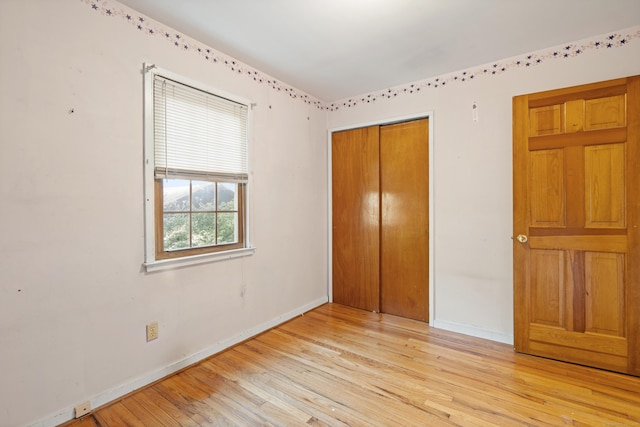 38 Skyline Dr, Brookfield, CT 06804 - unfurnished bedroom with baseboards, light wood-type flooring, and a closet