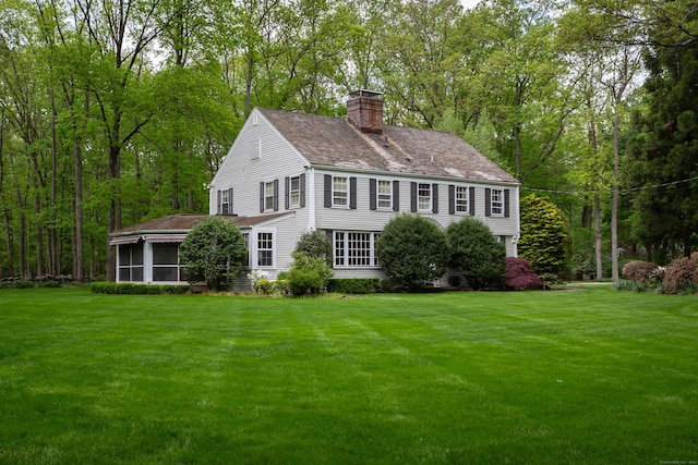 12 Crooked Mile Rd, Westport, CT 06880 - view of front of property with a chimney, a sunroom, and a front lawn