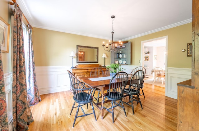 45 Wolf Pit Rd, Southbury, CT 06488 - dining space featuring a chandelier, wainscoting, ornamental molding, light wood-style floors, and a decorative wall