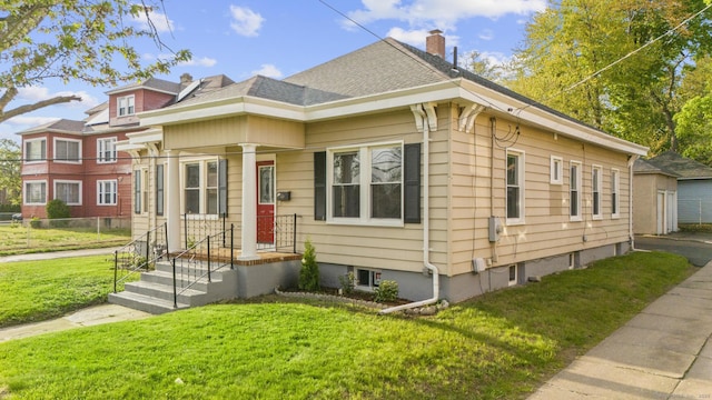 181 Westbourne Pkwy, Hartford, CT 06112 - view of front facade featuring fence, a shingled roof, a chimney, and a front yard