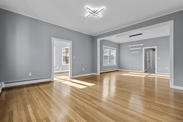 181 Westbourne Pkwy, Hartford, CT 06112 - unfurnished living room featuring crown molding, baseboards, a baseboard heating unit, light wood-style floors, and a baseboard radiator