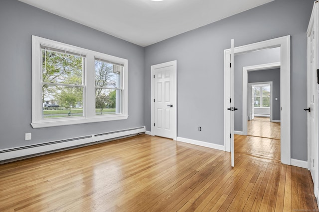 181 Westbourne Pkwy, Hartford, CT 06112 - unfurnished bedroom with a baseboard radiator, baseboards, and light wood-type flooring