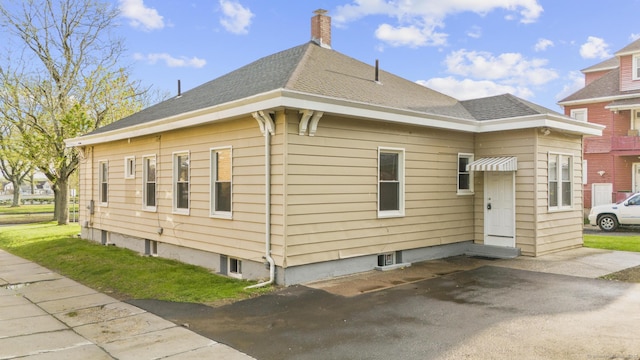 181 Westbourne Pkwy, Hartford, CT 06112 - view of home's exterior featuring roof with shingles and a chimney
