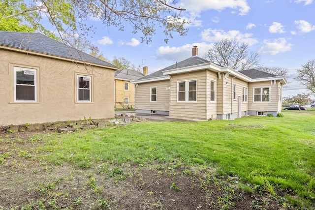 181 Westbourne Pkwy, Hartford, CT 06112 - back of house with a yard, a chimney, a patio, and roof with shingles