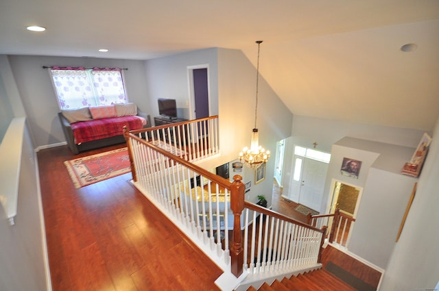 stairway featuring an inviting chandelier, recessed lighting, baseboards, and wood finished floors