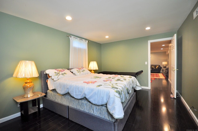 bedroom with wood finished floors, baseboards, and recessed lighting