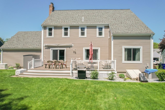 54 Silo Dr, Wethersfield, CT 06109 - back of house with a deck, a chimney, a lawn, and roof with shingles