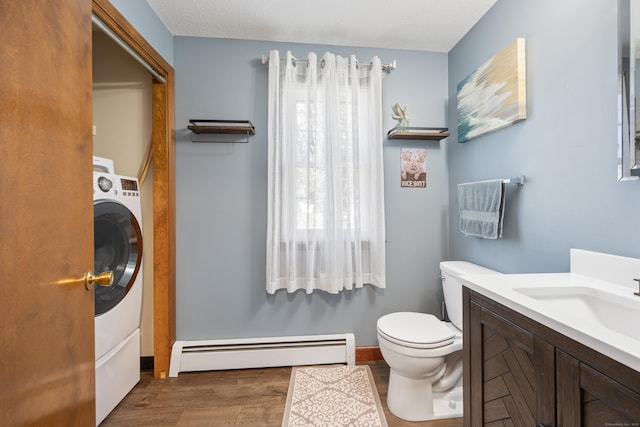 54 Silo Dr, Wethersfield, CT 06109 - bathroom featuring a baseboard radiator, wood finished floors, toilet, vanity, and washer / clothes dryer