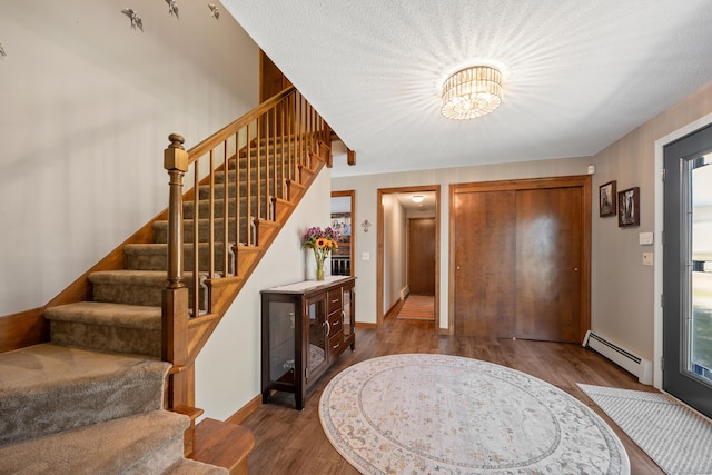 54 Silo Dr, Wethersfield, CT 06109 - entryway featuring baseboard heating, wood finished floors, stairway, and a chandelier