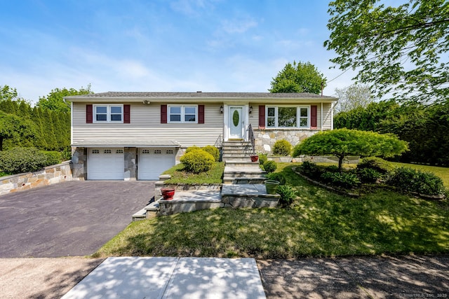 250 Glenn Dr, Stratford, CT 06614 - view of front of house featuring stone siding, a garage, asphalt driveway, a front lawn, and entry steps
