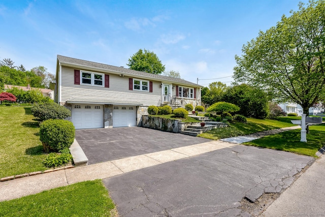 250 Glenn Dr, Stratford, CT 06614 - bi-level home featuring driveway, stone siding, an attached garage, and a front yard