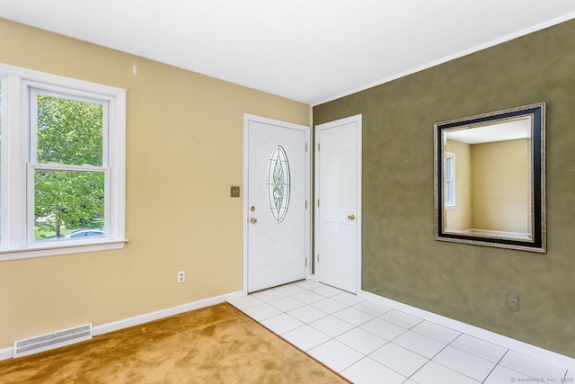 250 Glenn Dr, Stratford, CT 06614 - foyer entrance with baseboards, light colored carpet, and light tile patterned floors