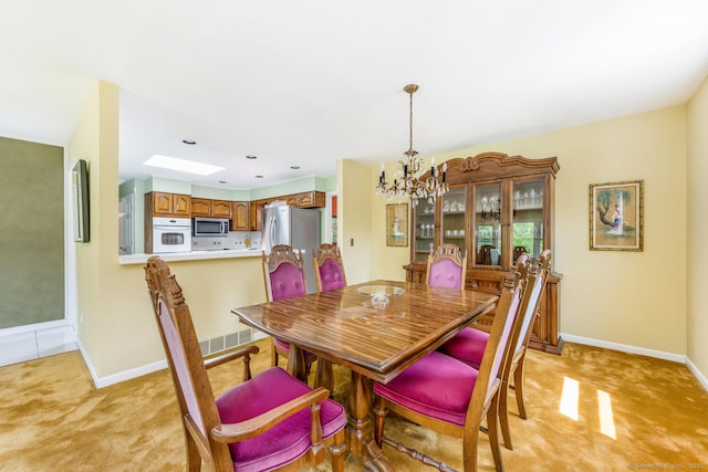 250 Glenn Dr, Stratford, CT 06614 - dining room with a chandelier, light carpet, and baseboards