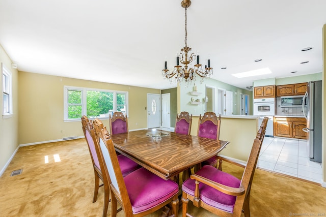 250 Glenn Dr, Stratford, CT 06614 - dining space with light colored carpet, a chandelier, and baseboards