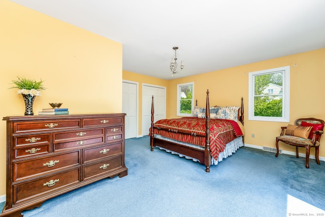 250 Glenn Dr, Stratford, CT 06614 - carpeted bedroom featuring baseboards, two closets, and a chandelier