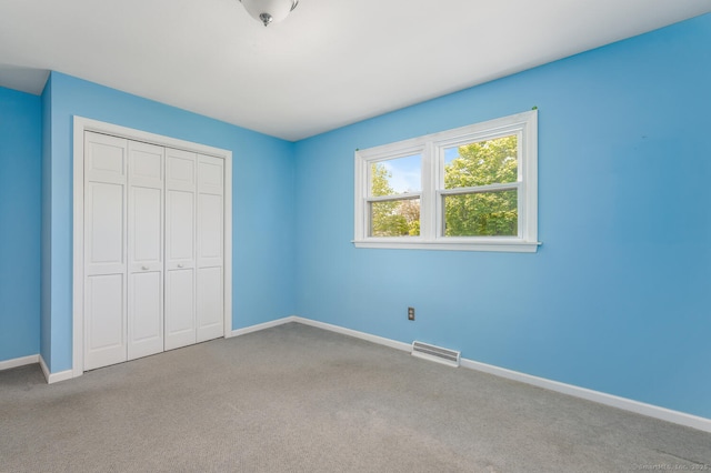 250 Glenn Dr, Stratford, CT 06614 - unfurnished bedroom featuring baseboards, carpet floors, and a closet