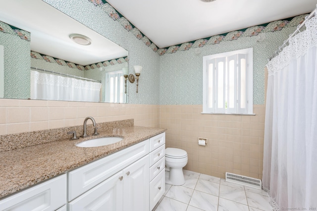 250 Glenn Dr, Stratford, CT 06614 - bathroom featuring tile walls, vanity, toilet, a wainscoted wall, and curtained shower