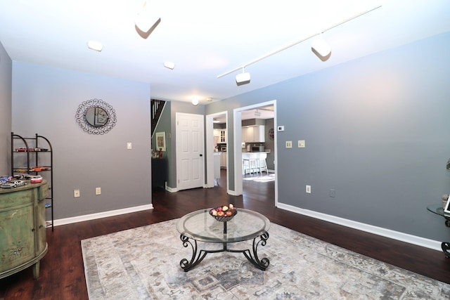 interior space with ceiling fan, baseboards, and wood finished floors