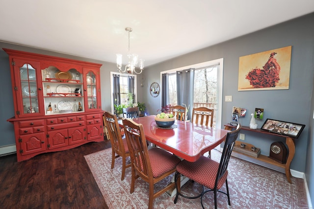 dining room featuring dark wood-style flooring and a chandelier