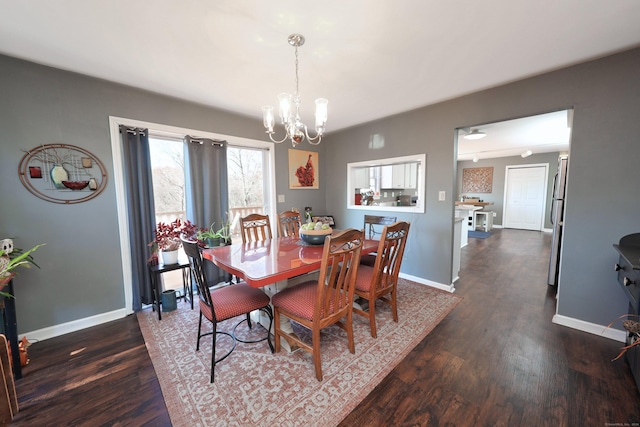 dining room with an inviting chandelier, baseboards, and dark wood finished floors