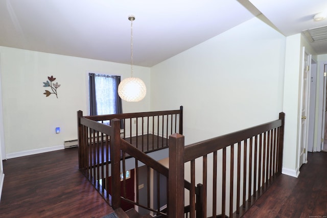 staircase with baseboards, a baseboard radiator, visible vents, and wood finished floors