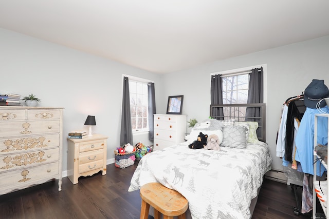 bedroom featuring baseboards and dark wood-style flooring