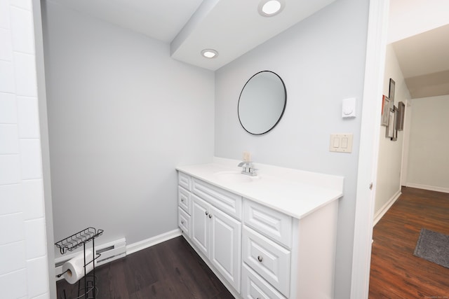bathroom with vanity, recessed lighting, baseboards, and wood finished floors
