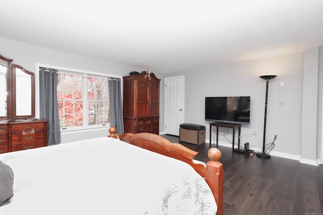 bedroom with baseboards and dark wood-style floors