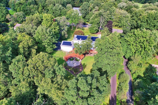 birds eye view of property with a wooded view