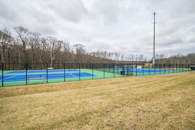 exterior space featuring a yard, a tennis court, and fence