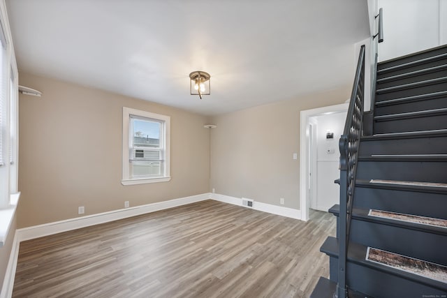 interior space featuring baseboards, visible vents, and wood finished floors