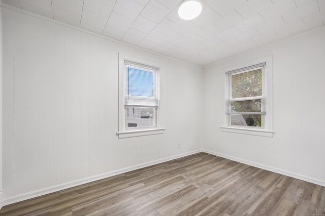 spare room with wood finished floors and baseboards