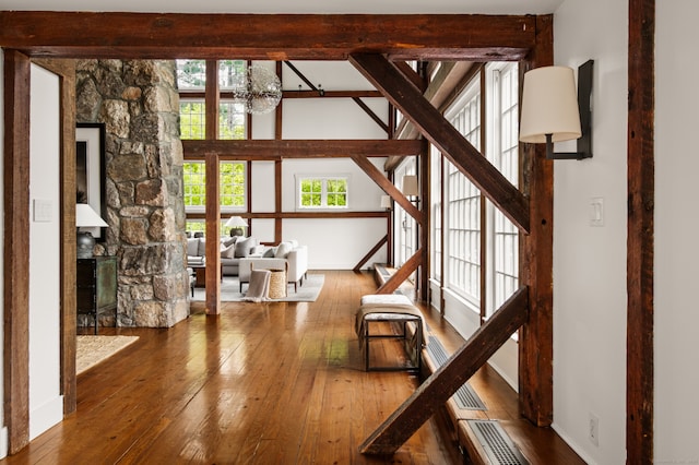 945 Oenoke Rdg, New Canaan, CT 06840 - living area with wood-type flooring, a chandelier, stairs, beam ceiling, and baseboards