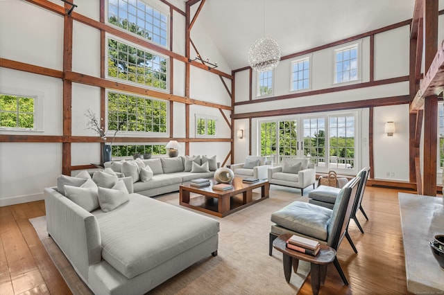 945 Oenoke Rdg, New Canaan, CT 06840 - living room with high vaulted ceiling, hardwood / wood-style flooring, baseboards, and plenty of natural light