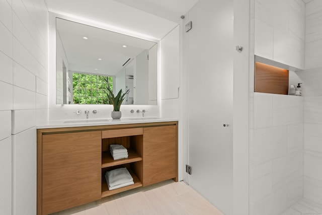 945 Oenoke Rdg, New Canaan, CT 06840 - bathroom with double vanity, tiled shower, and recessed lighting