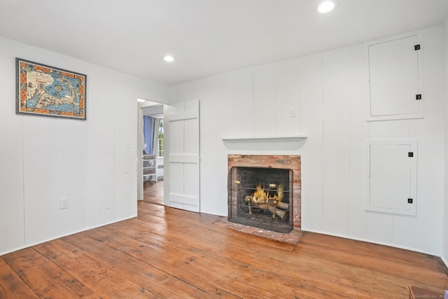 455 E St, Middletown, CT 06457 - unfurnished living room featuring hardwood / wood-style flooring, a fireplace, recessed lighting, and a decorative wall
