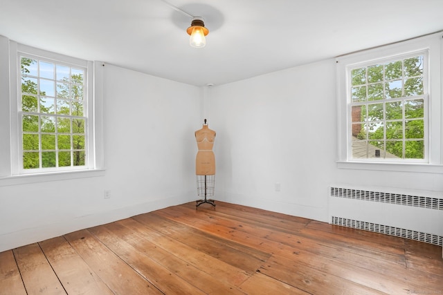 455 E St, Middletown, CT 06457 - empty room featuring radiator heating unit, hardwood / wood-style flooring, and healthy amount of natural light