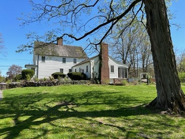 455 E St, Middletown, CT 06457 - view of side of property featuring a chimney and a yard