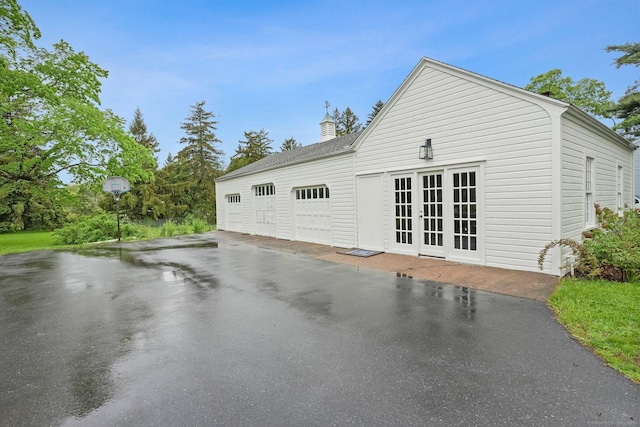 455 E St, Middletown, CT 06457 - view of property exterior with french doors, an attached garage, and driveway