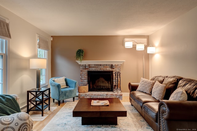 living area with light wood-type flooring and a fireplace