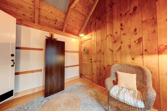 living area with wood ceiling, wood finished floors, and wood walls