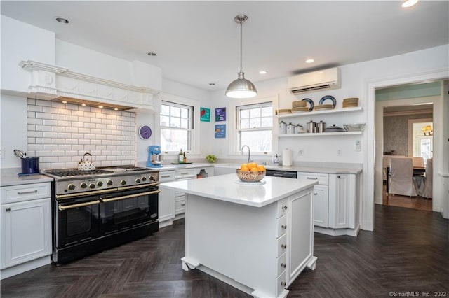 262 Kenyon St, Hartford, CT 06105 - kitchen with range with two ovens, a wall mounted AC, light countertops, open shelves, and white cabinetry